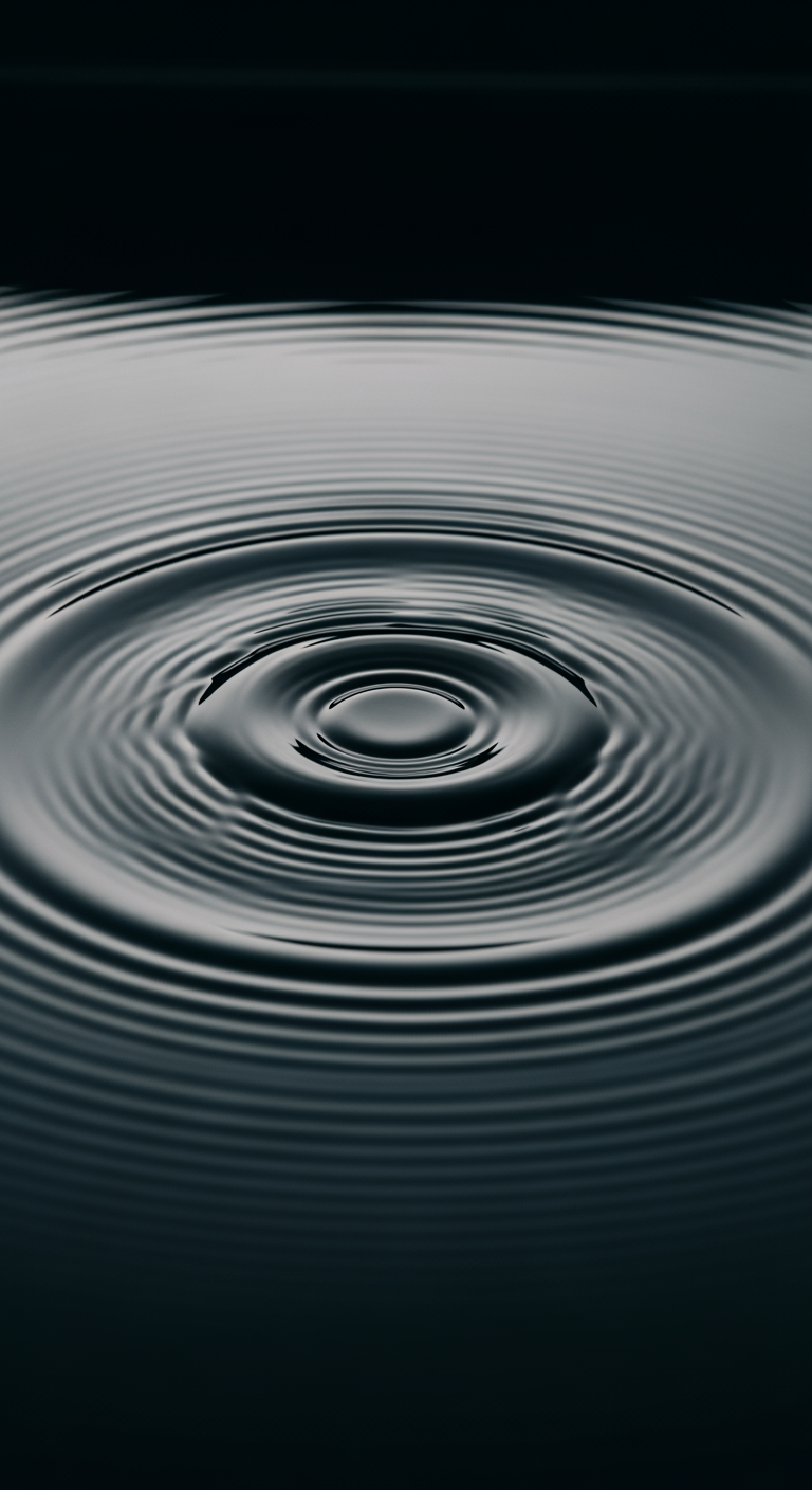 A close-up abstract image of perfect, circular ripples spreading on dark water, representing the science of sound waves.
