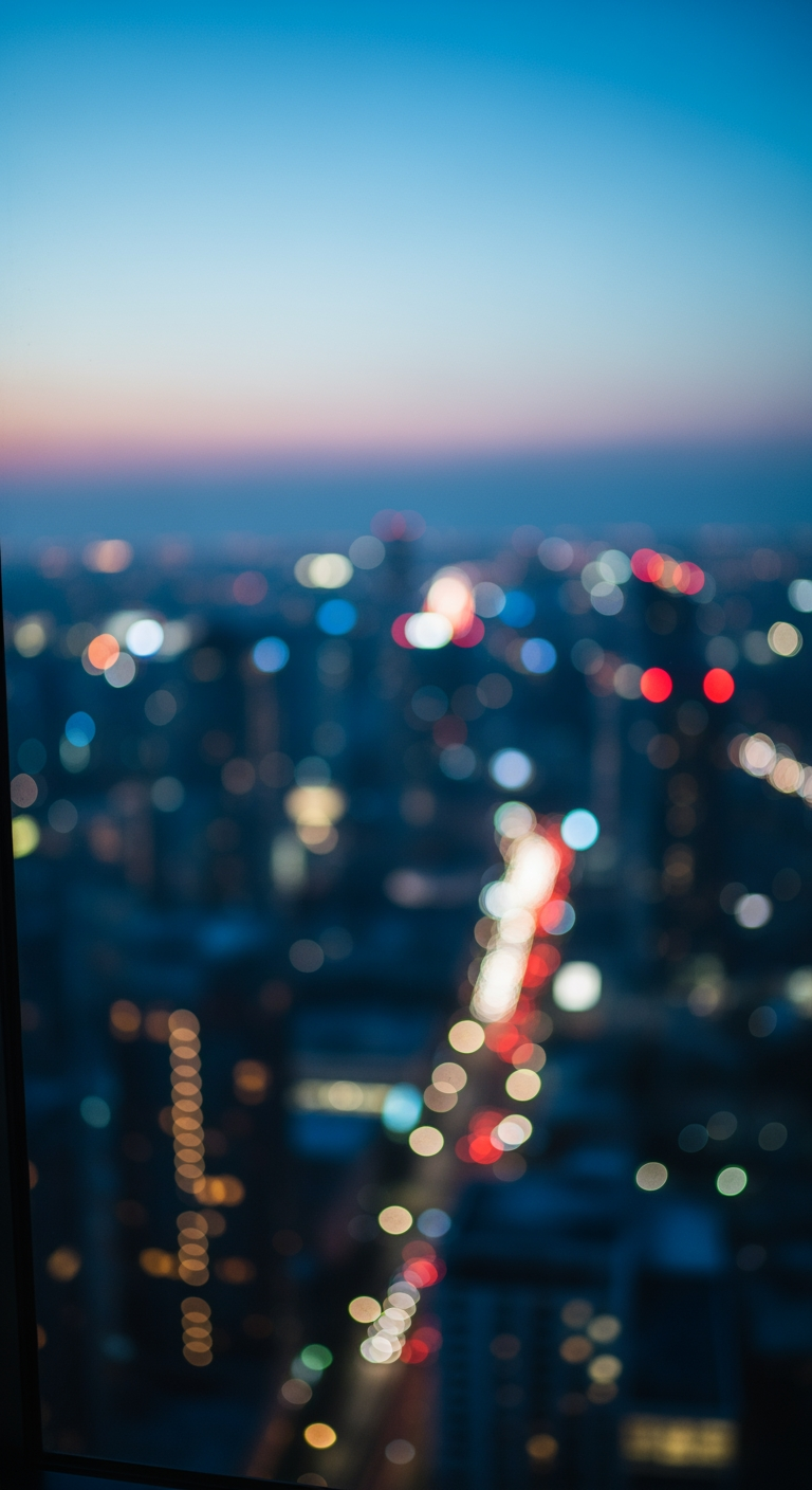 A peaceful view of a city at dusk from a hotel window, with lights blurred into soft bokeh, signifying a calm night.