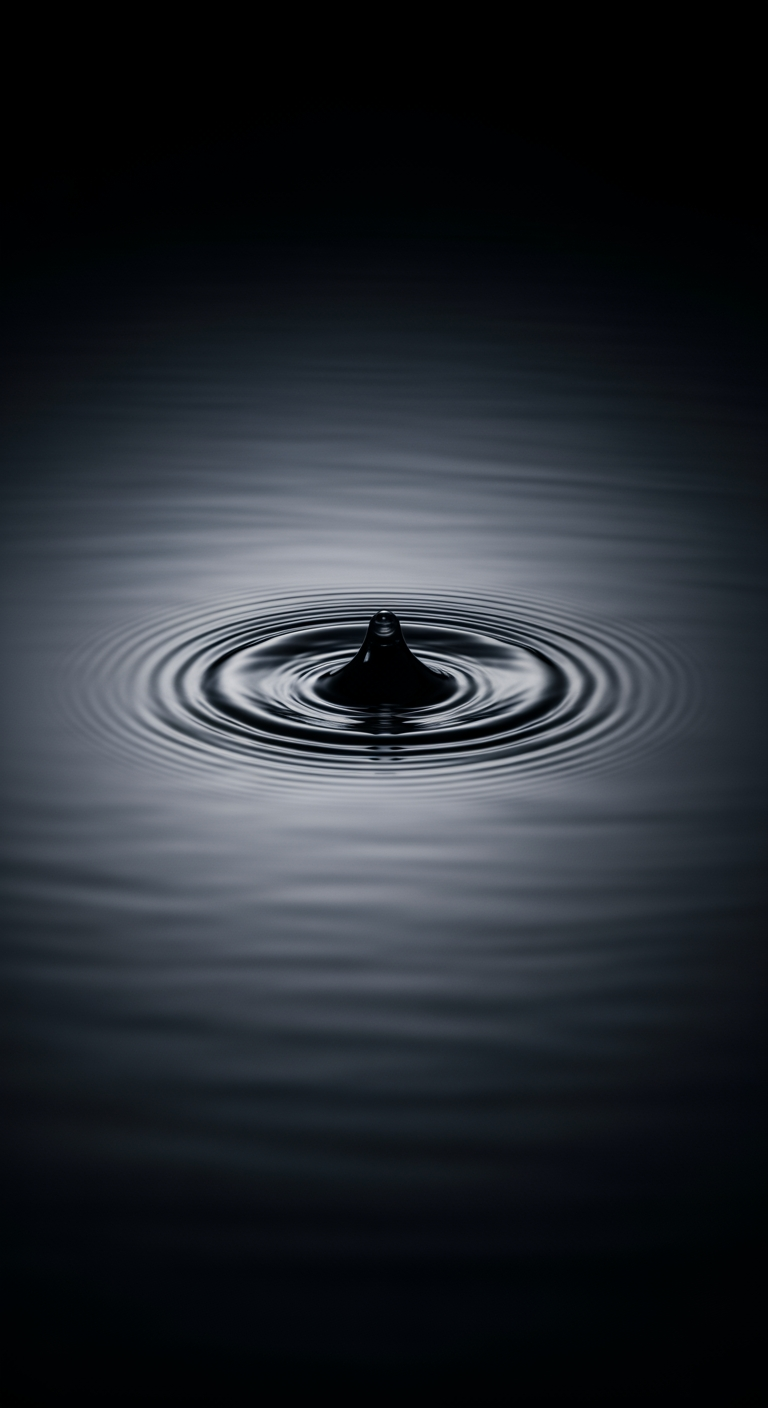 A single, soft ripple expands across the surface of calm, dark water, representing a baby's startle reflex.