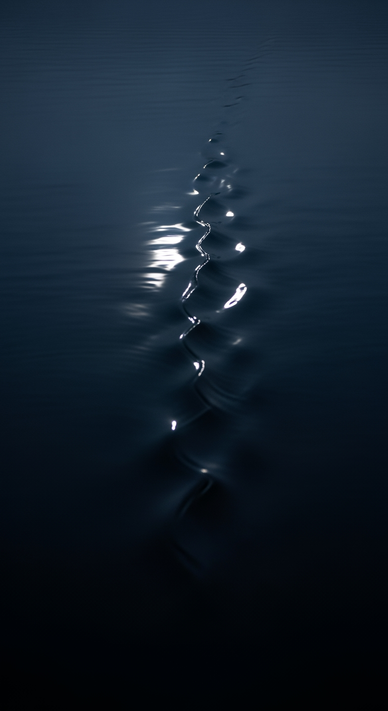 A single, soft ripple moves across a very dark, calm surface of water at night, symbolizing long, consolidated sleep.
